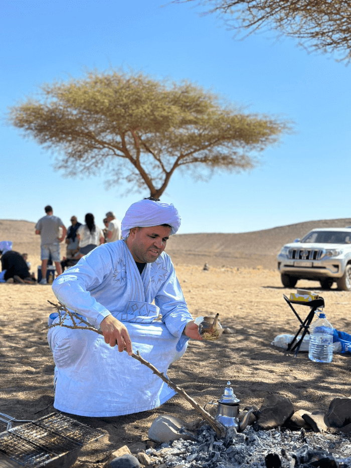 Berber man preparing traditional tea in the desert